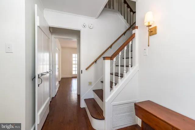a kitchen with stainless steel appliances granite countertop a sink a stove a microwave and wooden floors