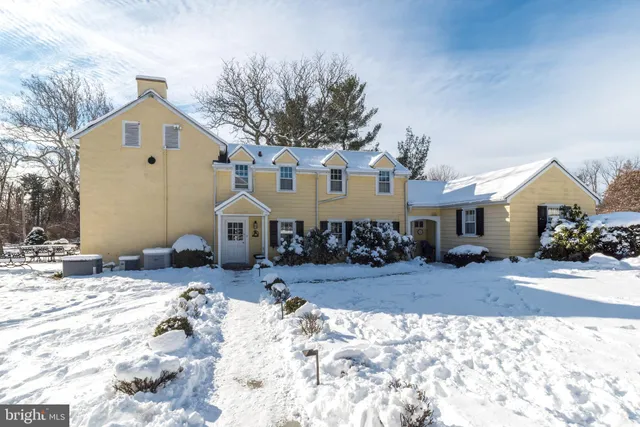 a view of a trees in front of a house with a big yard