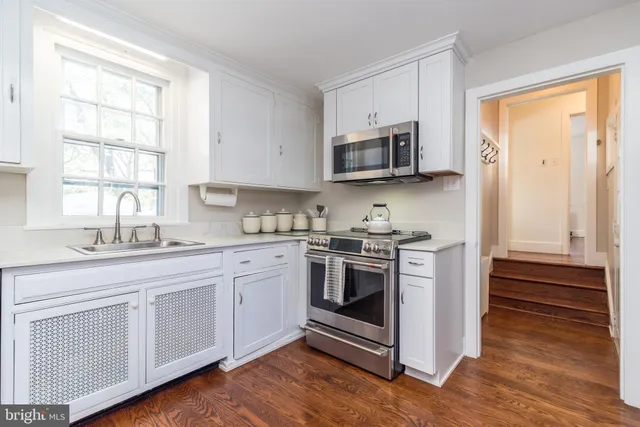 a view of a livingroom with wooden floor and a window