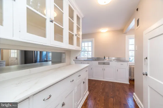 a view of a patio with table and chairs and wooden floor
