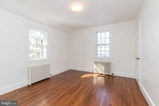 a view of a yard with wooden fence