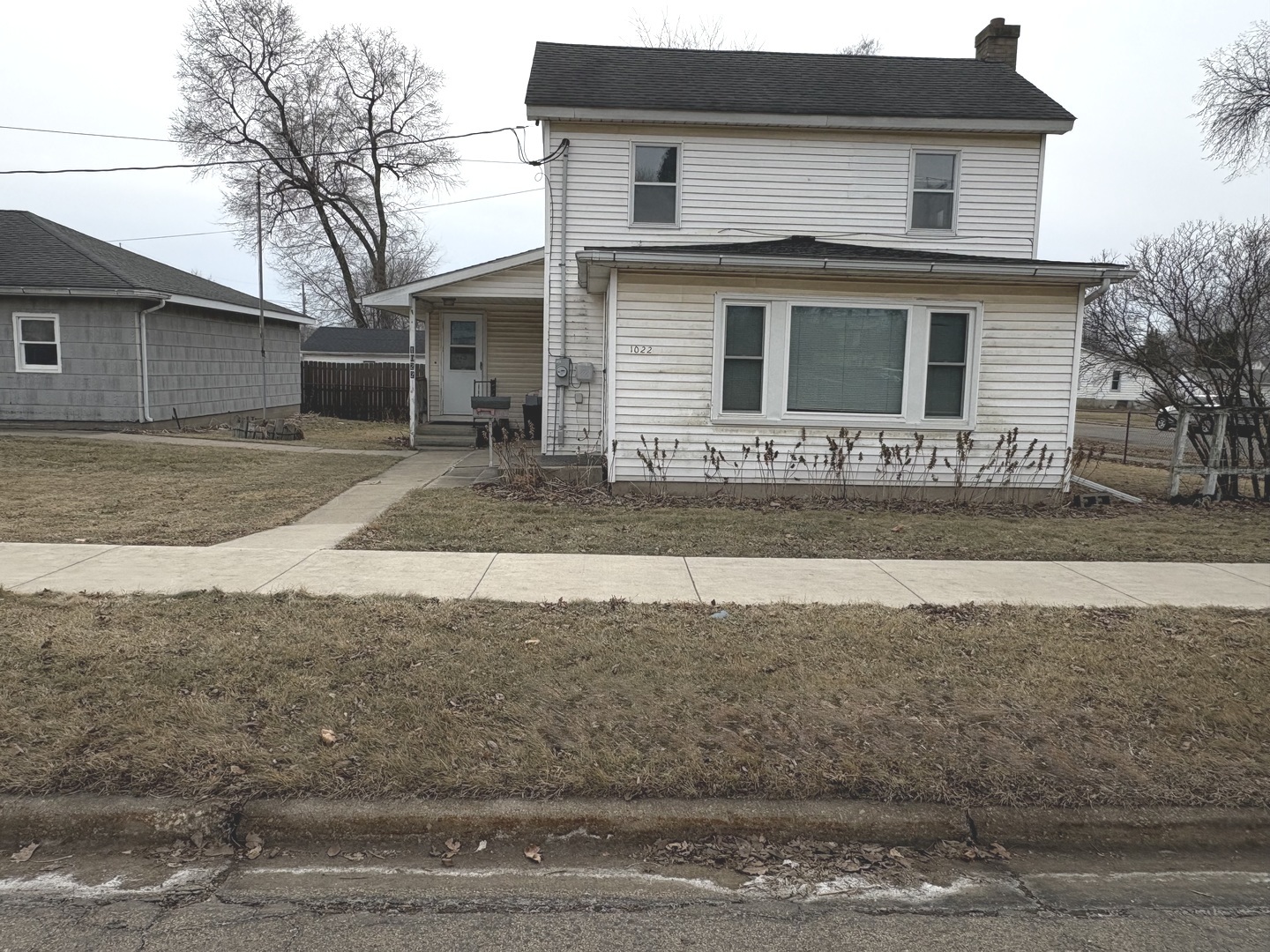 1022 1st Avenue Rochelle, IL 61068 - Photo 1 of 31 a front view of a house with a yard