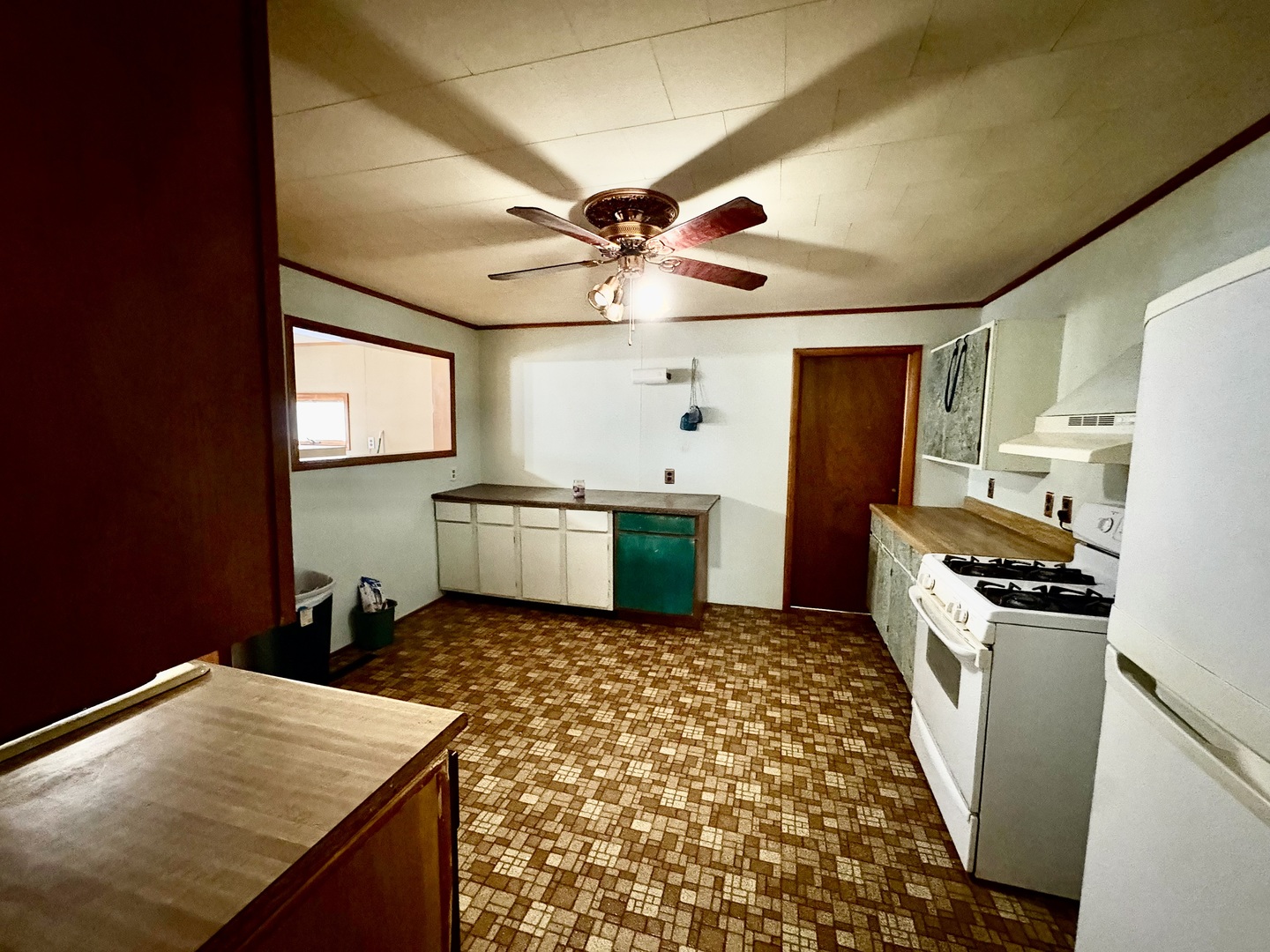 1022 1st Avenue Rochelle, IL 61068 - Photo 6 of 31 a kitchen with a sink a stove cabinets and a refrigerator