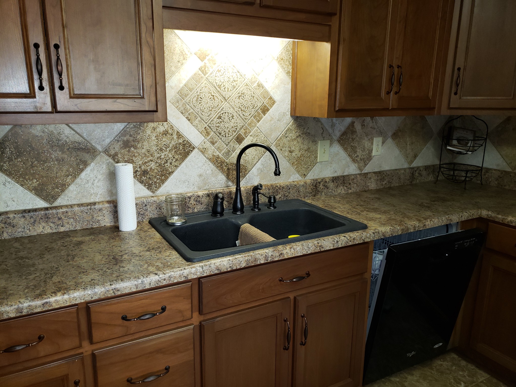 55 Short Creek Road Dellrose, TN 38453 - Photo 10 of 34 a kitchen with granite countertop a sink and a wooden cabinets