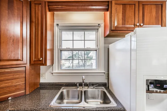 a bathroom with a toilet a sink a bath tub and a window