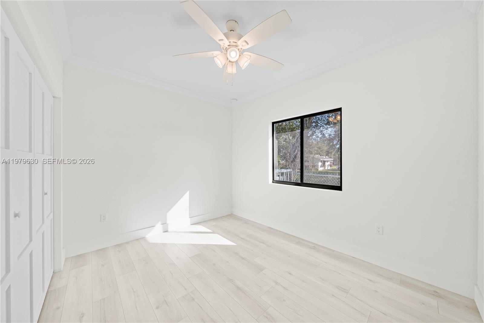 1735 Northwest 84th Street Miami, FL 33147 - Photo 11 of 26 an empty room with a window and a fan