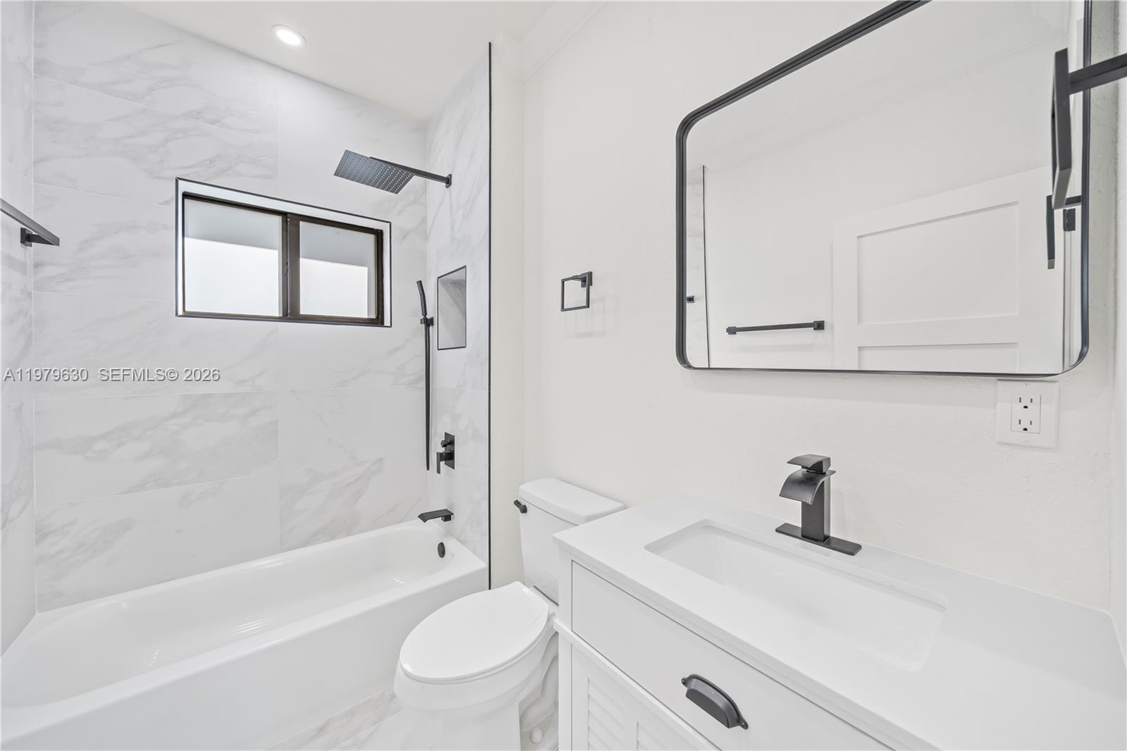 1735 Northwest 84th Street Miami, FL 33147 - Photo 12 of 26 a bathroom with a sink a toilet and a bathtub