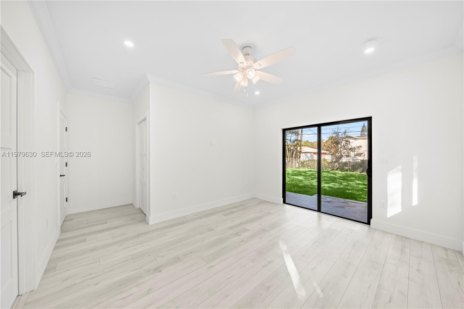 1735 Northwest 84th Street Miami, FL 33147 - Photo 15 of 26 an empty room with fan and windows