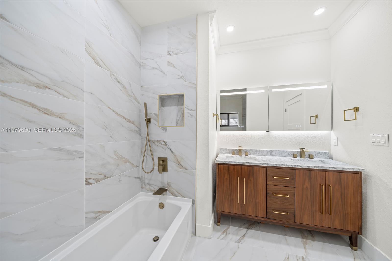 1735 Northwest 84th Street Miami, FL 33147 - Photo 17 of 26 a bathroom with a granite countertop sink mirror and bathtub