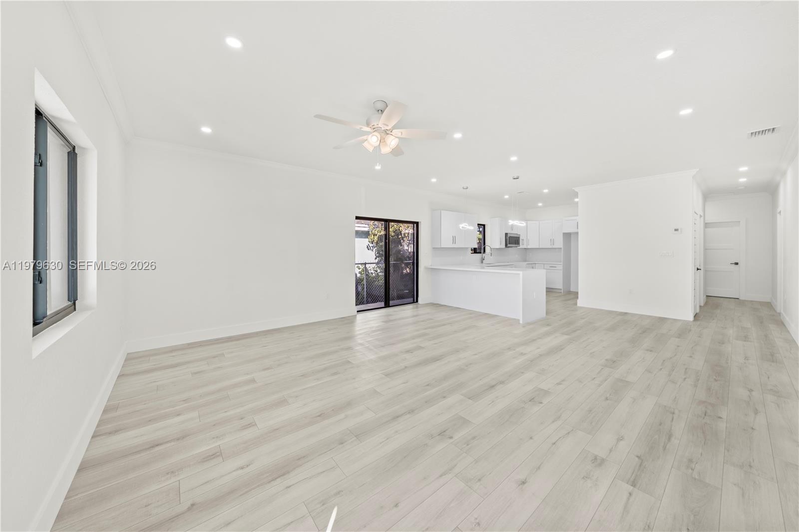 1735 Northwest 84th Street Miami, FL 33147 - Photo 6 of 26 a view of a kitchen with a sink and a refrigerator