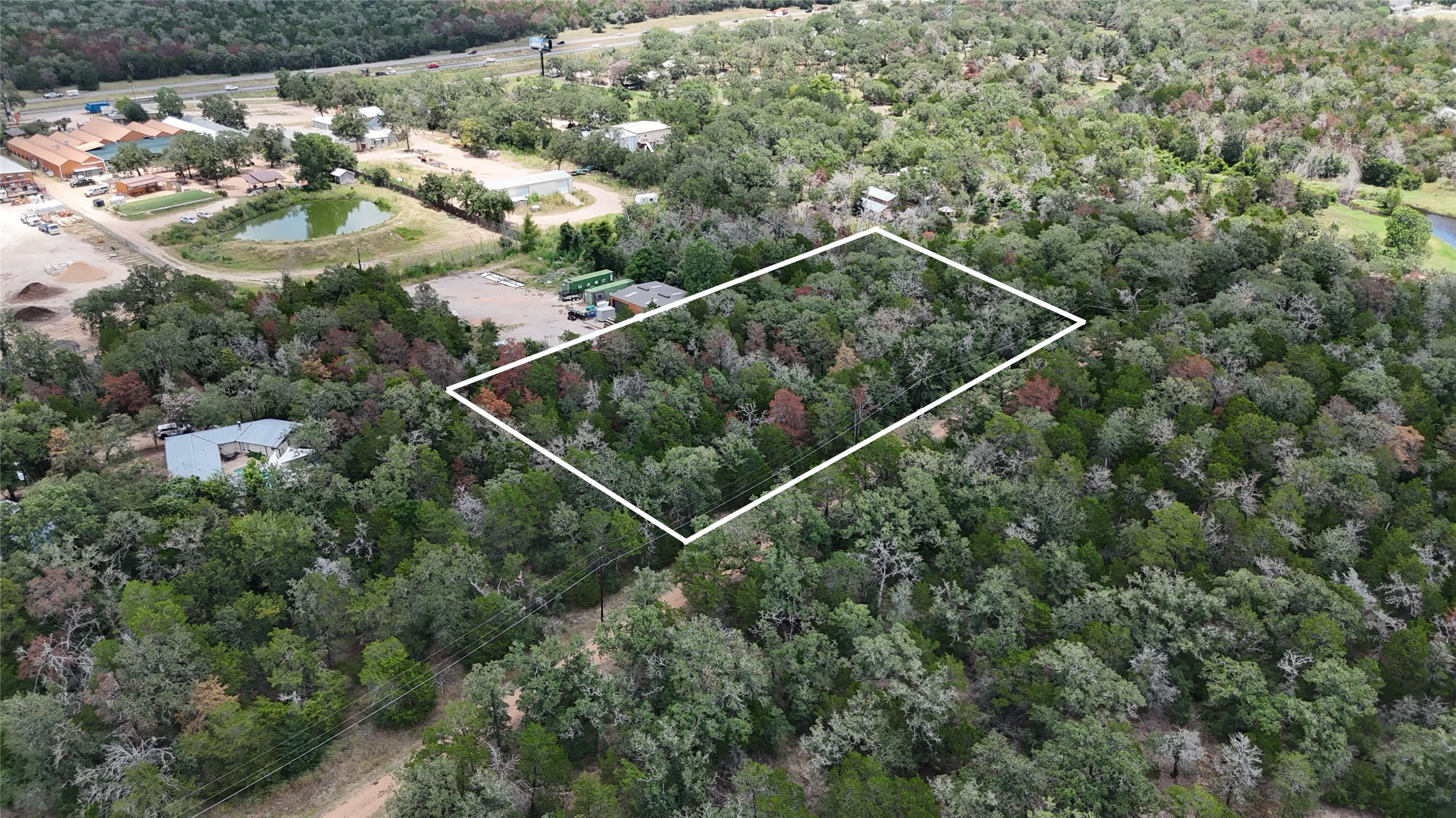 Tbd Red Fox Lane Bastrop, TX 78602 - Photo 8 of 14 A verdant, undeveloped land parcel offers privacy and natural beauty, ready for custom construction.