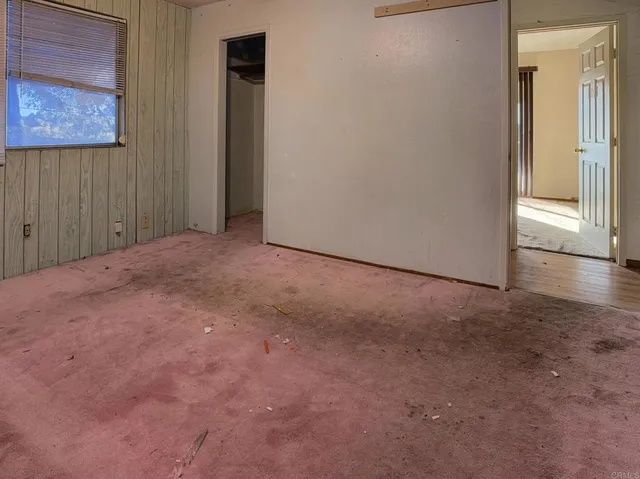 a view of a livingroom with a ceiling fan and window