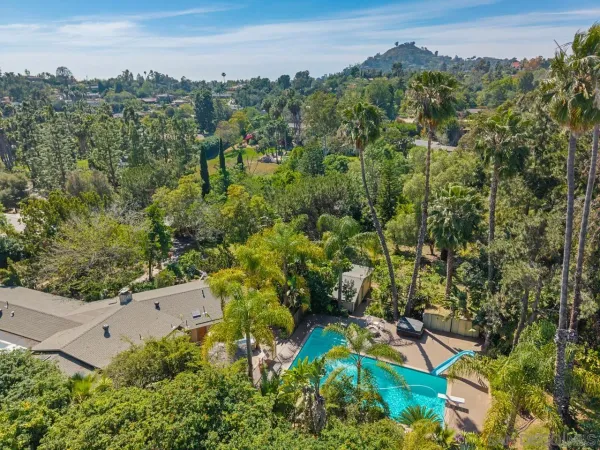 an aerial view of a house with a yard