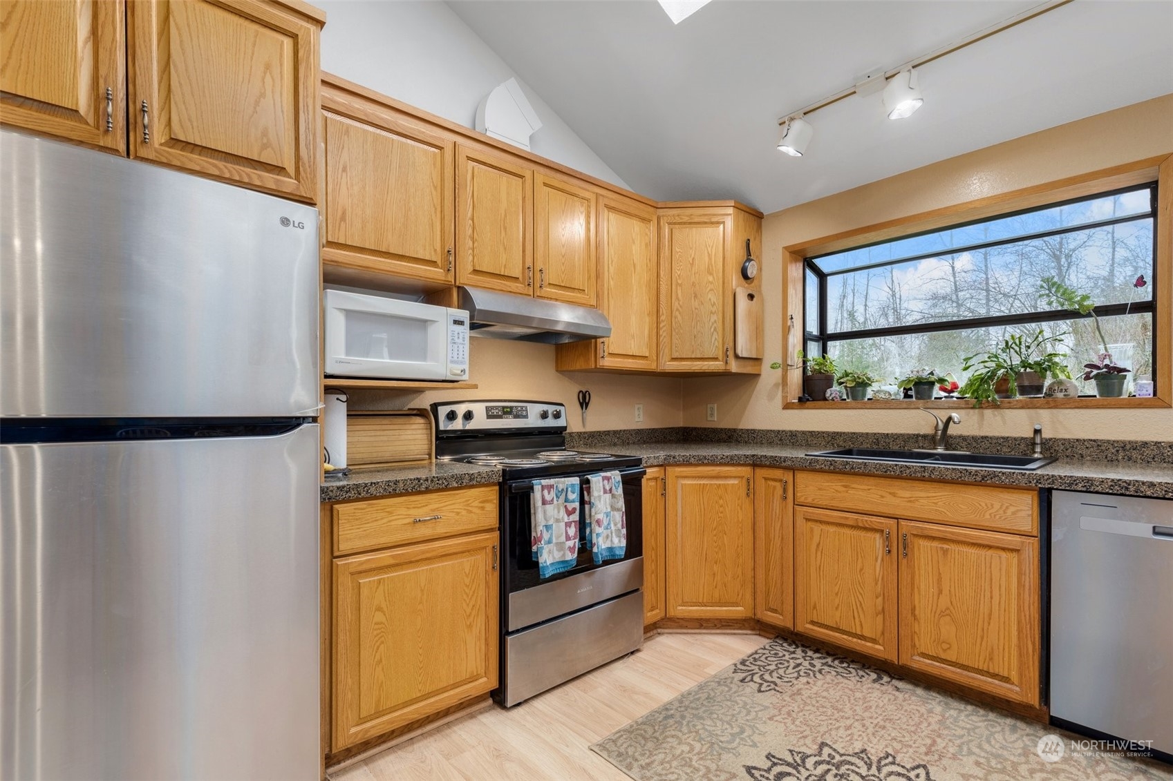 20615 Brown Road Monroe, WA 98272 - Photo 18 of 36 a kitchen with stainless steel appliances granite countertop a refrigerator sink and cabinets