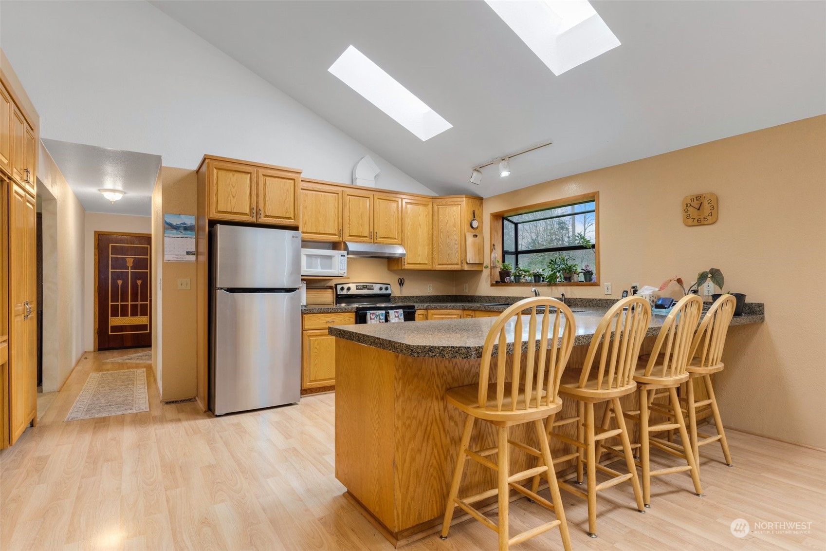 20615 Brown Road Monroe, WA 98272 - Photo 19 of 36 a kitchen with stainless steel appliances kitchen island granite countertop a refrigerator a stove a sink dishwasher with a dining table and chair