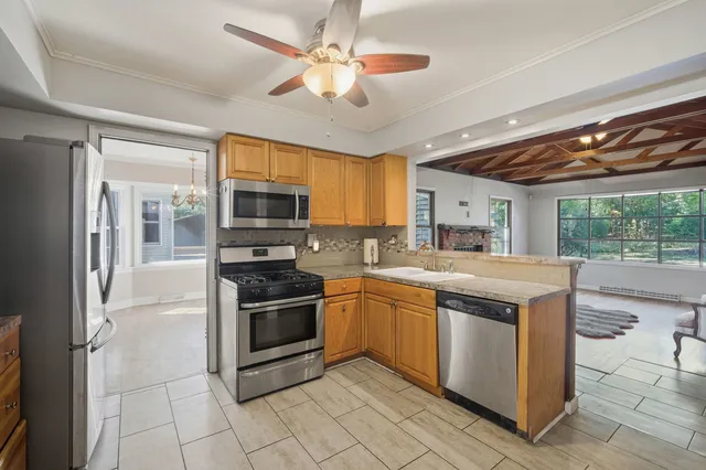 a kitchen with stainless steel appliances granite countertop a stove and a refrigerator