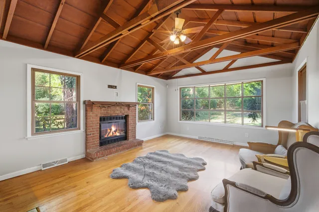 a living room with furniture a window and a fireplace