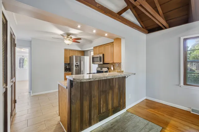 a spacious bedroom with a large bed and a large window