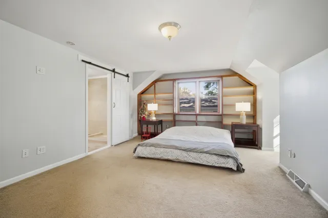 a spacious bathroom with a double vanity sink a large mirror and shower