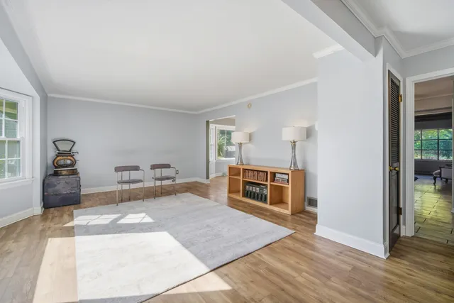 a spacious bedroom with a bed and a dresser