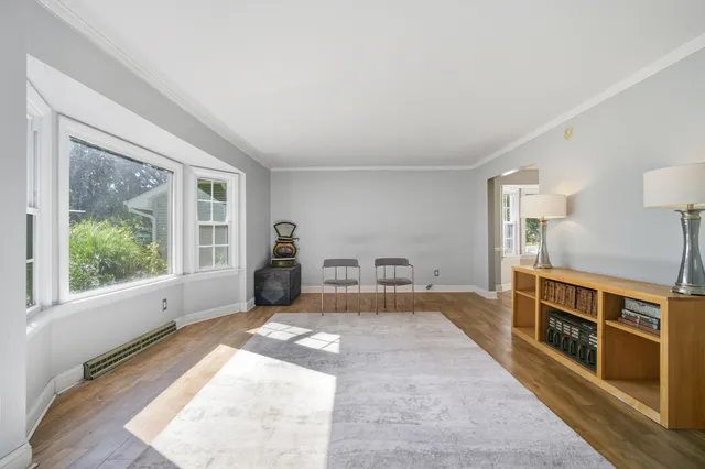 a view of a bedroom with furniture window and wooden floor