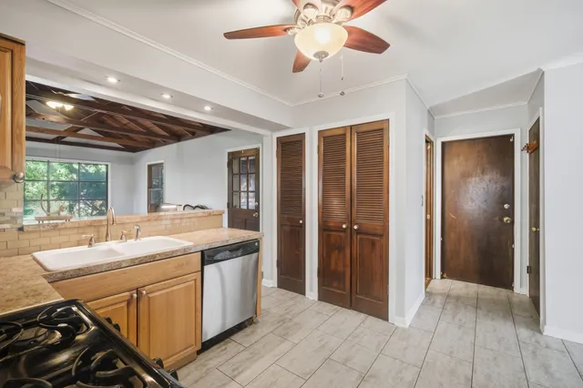 a view of a kitchen with a sink and a window