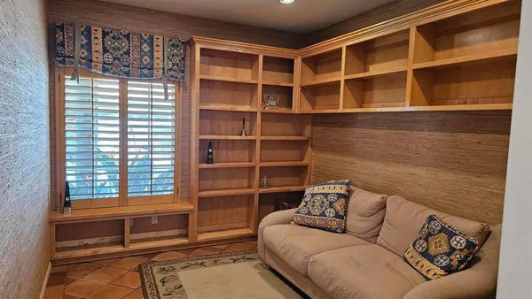 a living room with a couch and a bookshelf