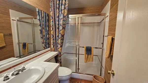 a bathroom with a sink toilet and shower