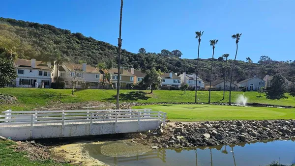 a view of a house with a yard and a large pool