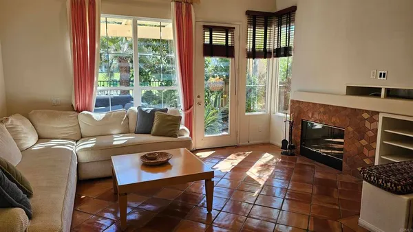 a living room with furniture a window and a fireplace