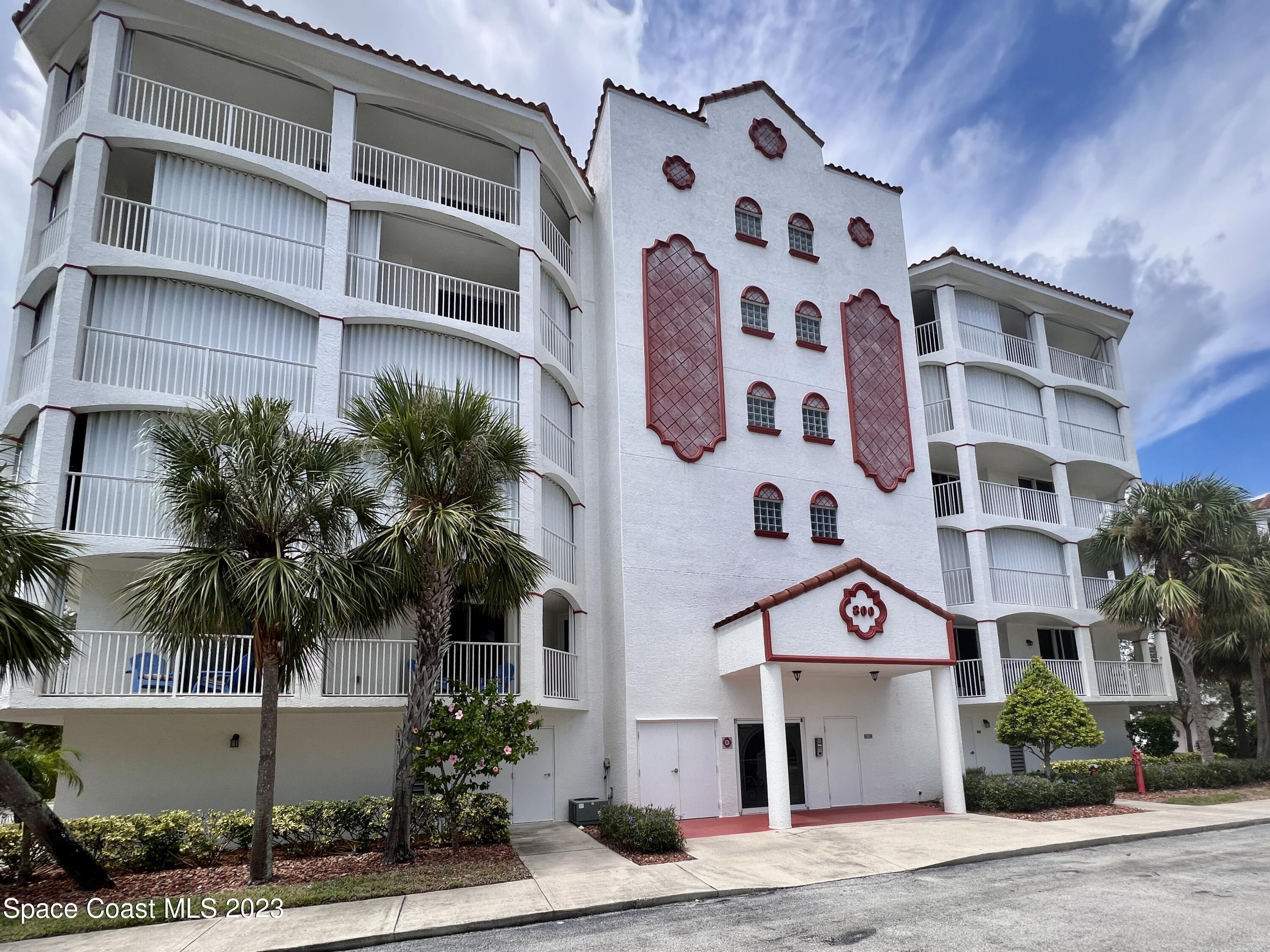 800 Del Rio Way, Unit 402 Merritt Island, FL 32953 - Photo 1 of 24 a front view of a building with potted plants