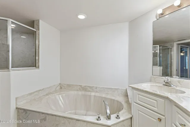 a bathroom with a shower and a bath tub
