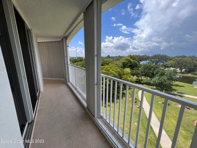 a view of balcony with wooden floor and fence
