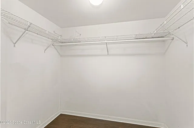 a view of a room with wooden floor and windows