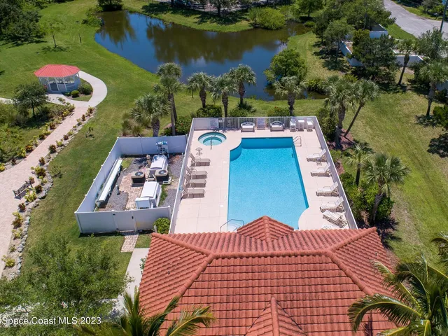 an aerial view of a house with garden space and lake view