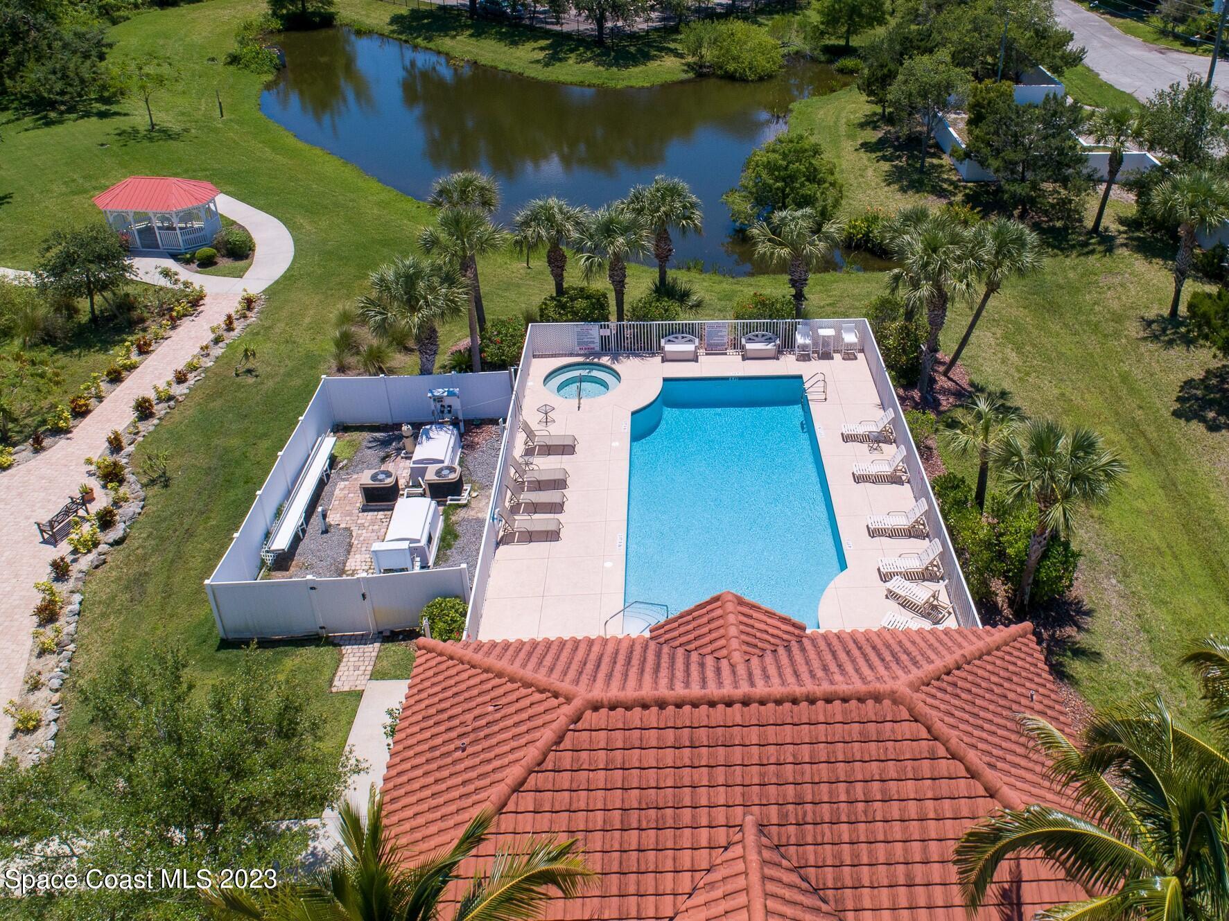 800 Del Rio Way, Unit 402 Merritt Island, FL 32953 - Photo 18 of 24 an aerial view of a house with garden space and lake view
