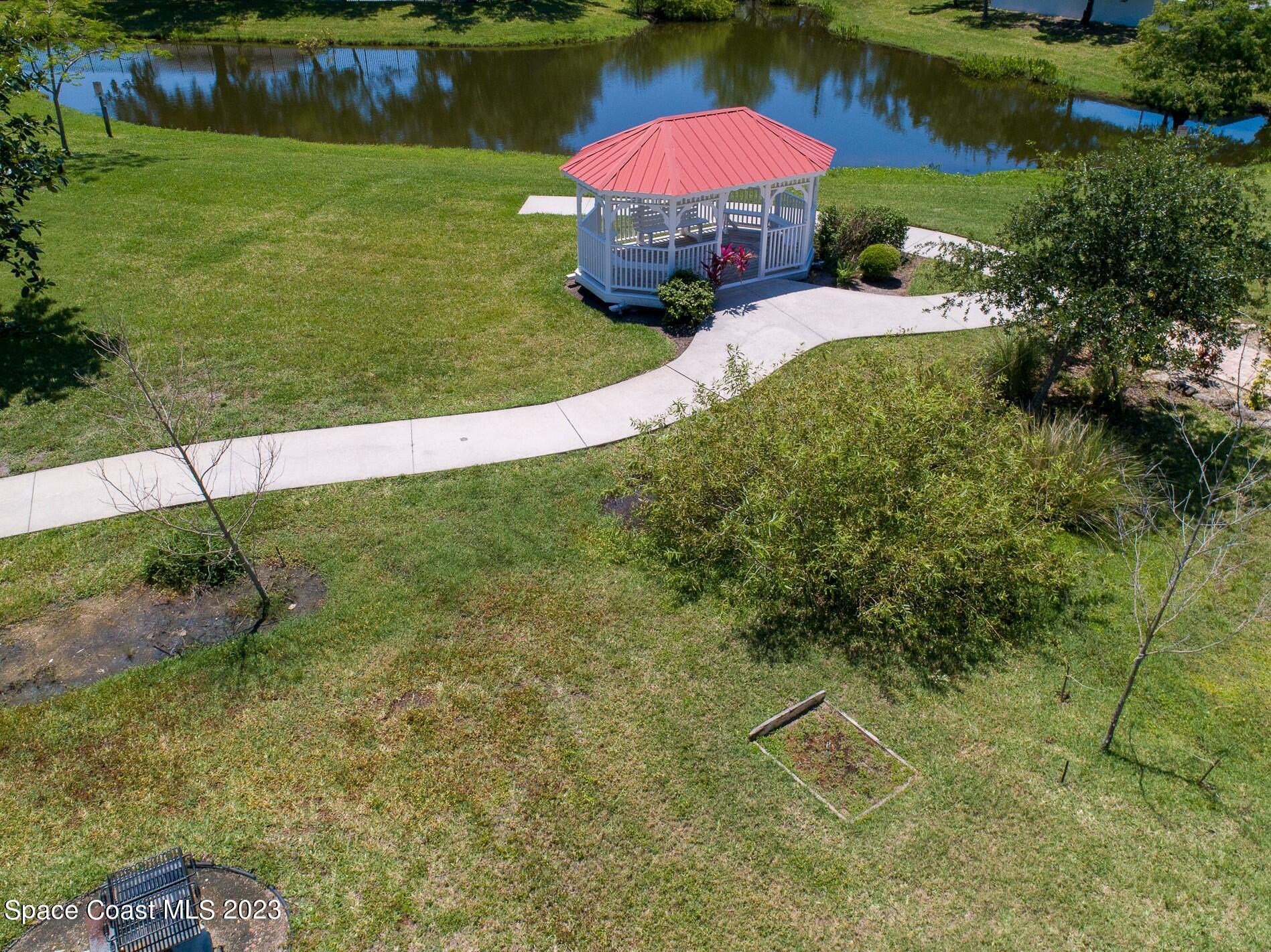 800 Del Rio Way, Unit 402 Merritt Island, FL 32953 - Photo 23 of 24 a view of a swimming pool with a yard