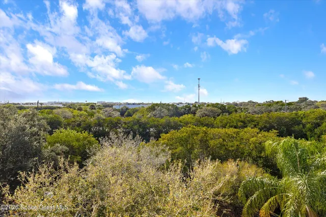 a view of a room with furniture and windows
