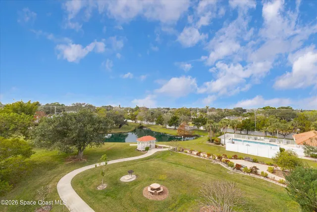 a view of a house with pool and chairs