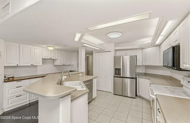 a kitchen with granite countertop a refrigerator and a sink