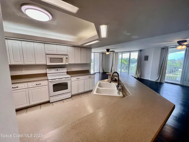 a kitchen with microwave a stove and cabinets