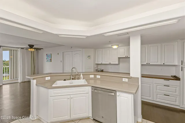 a view of a kitchen with a dishwasher and wooden floor