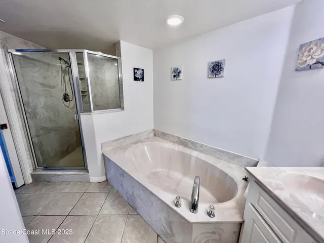 a bathroom with a tub a toilet and a shower