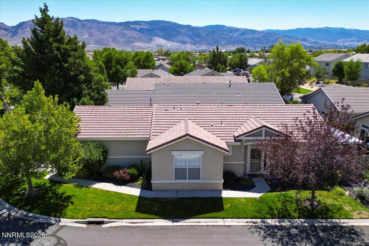 1612 Mountain Lane Reno, NV 89521 - Photo 3 of 36 a front view of a house with a yard and street