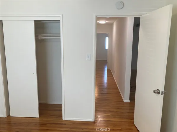 a view of a hallway with wooden floor