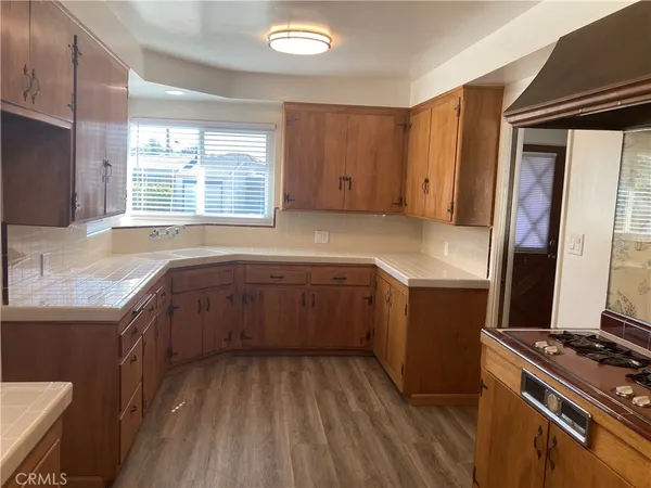 a kitchen with wooden cabinets and a sink