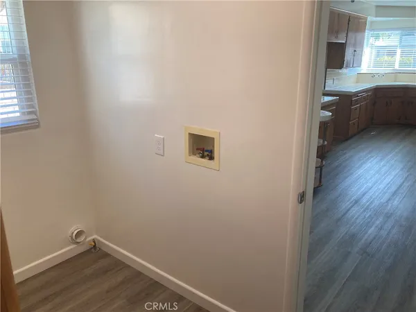 a view of a room with wooden floor and a sink