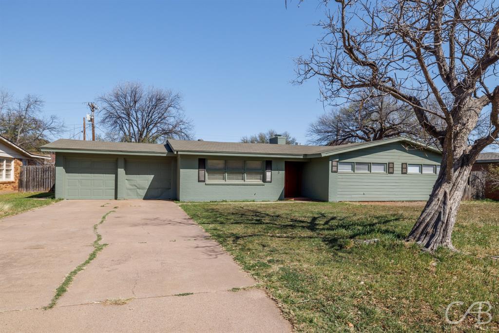 3318 Green Acres Road Abilene, TX 79605 - Photo 1 of 1 Single story home featuring a front yard, concrete driveway, a chimney, fence, and a garage