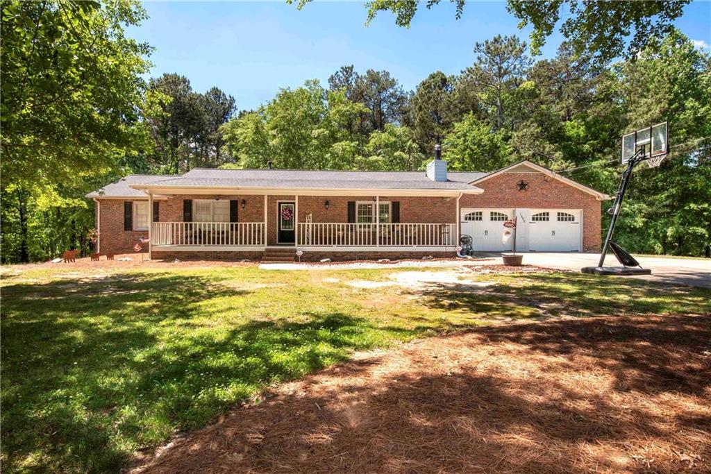 1880 Holman Road Hoschton, GA 30548 - Photo 1 of 1 a front view of a house with a big yard
