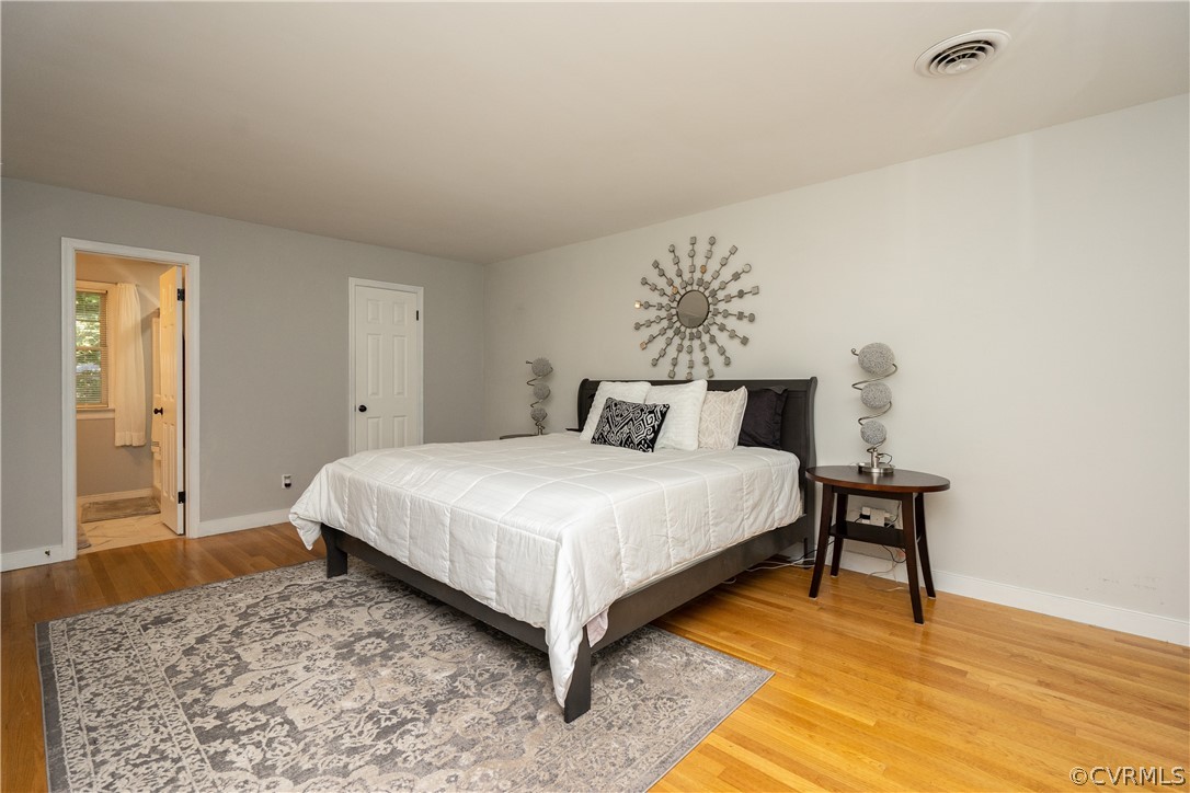 11330 Poplar Ridge Road Chesterfield, VA 23236 - Photo 19 of 32 a bedroom with a bed and wooden floor
